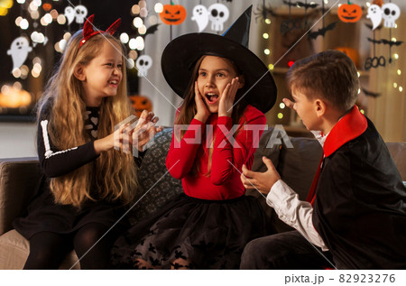 kids in halloween costumes playing at home kids in halloween costumes playing at home 82923276