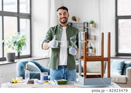 man painting old table in grey color at home man painting old table in grey color at home 82923479