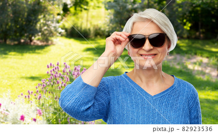 smiling senior woman in black sunglasses 82923536