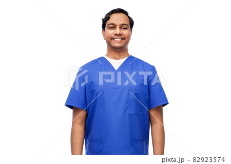 happy indian doctor or male nurse in blue uniform 82923574