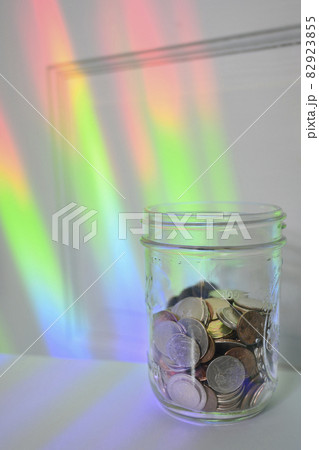Jar of coins with rainbow light 82923855
