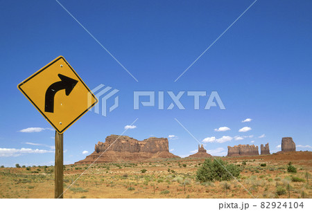 Arizona, Monument Valley Tribal Park, Road sign in Monument Valley with West and East Mitten Buttes in background 82924104