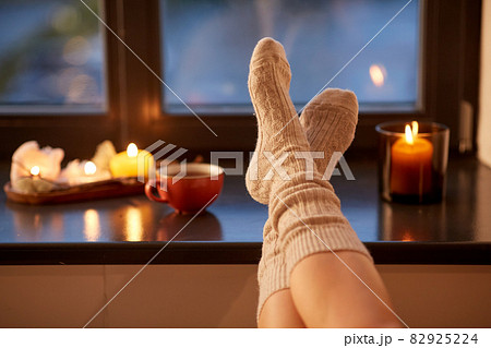 legs in socks on window sill at home in autumn 82925224