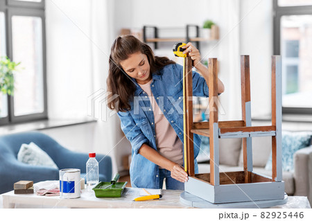 woman with ruler measuring table for renovation woman with ruler measuring table for renovation 82925446