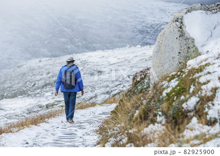 Australia, New South Wales, Woman hiking on snowy trail at Charlotte Pass in Kosciuszko National Park Australia, New South Wales, Woman hiking on snowy trail at Charlotte Pass in Kosciuszko National Park 82925900