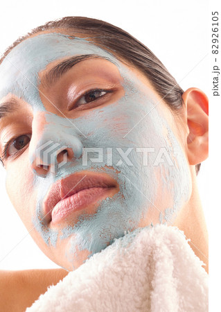 Close-up of woman removing blue facial mask 82926105