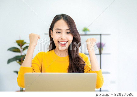 Excited female feeling euphoric celebrating online win success achievement result 82927036