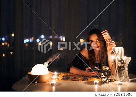 Gypsy fortune teller shuffling occult tarot cards. Magical pagan destiny reading ritual. 82931006