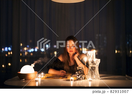 Woman reading tarot cards in spiritual room. 82931007