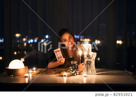 Gypsy fortune teller shuffling occult tarot cards. Magical pagan destiny reading ritual. 82931021