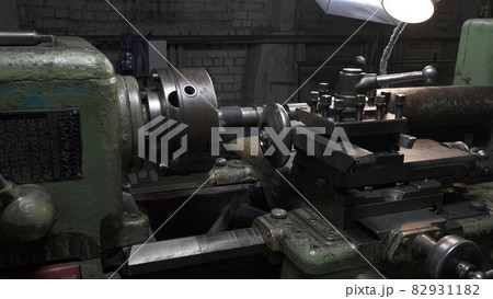 Working process with metal details on lathe in workplace 82931182