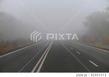 Bad weather driving - foggy hazy country road. Motorway - road traffic. Winter time. 82931573