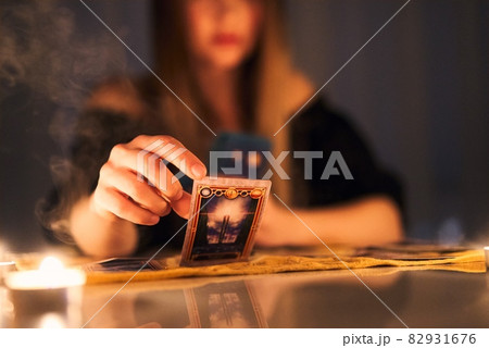 Woman reading tarot cards in spiritual room. 82931676