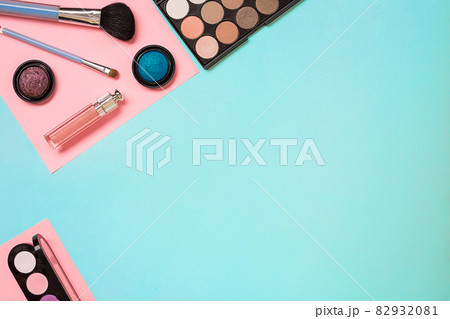 Make up essentials. Set of professional make up brushes, creams and shadows in jars on blue background. Make up essentials. Set of professional make up brushes, creams and shadows in jars on blue background. 82932081