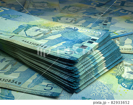 Canadian money. Canadian dollar banknotes. 5 CAD dollars bills. Canadian money. Canadian dollar banknotes. 5 CAD dollars bills. 82933652