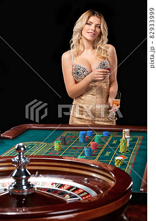woman in a smart dress plays roulette. woman in a smart dress plays roulette. 82933999