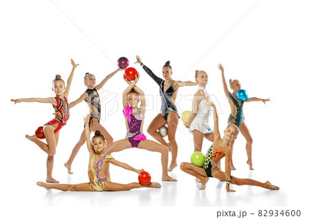 Portrait of group of little female rhythmic gymnastics artists isolated on white studio background. Concept of sport, action, team, show 82934600