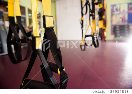 Gym interior with equipment, black and yellow belts. Gym interior with equipment, black and yellow belts. 82934813