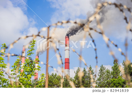 plant pipe with smoke against blue sky 82941639