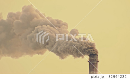 This smoke coming from the chimney in a factory. Harmful emissions into the atmosphere, from the pipe. Serious damage the environment. 82944222