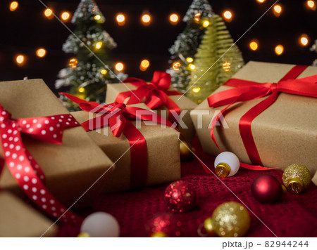 Gift boxes and christmas balls against bokeh lights background 82944244