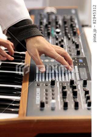 musician making music with analog synthesizer musician making music with analog synthesizer 82945312