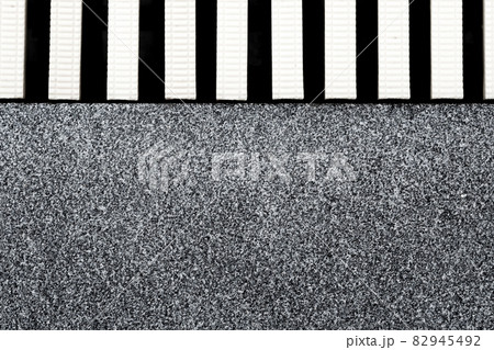 The surface texture of the marble remnants finish flooring and the plastic gutter cover beside the pool The surface texture of the marble remnants finish flooring and the plastic gutter cover beside the pool 82945492