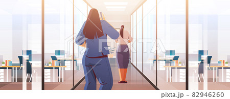 businesswomen couple standing back to camera rear view of business people in office corridor cartoon characters businesswomen couple standing back to camera rear view of business people in office corridor cartoon characters 82946260