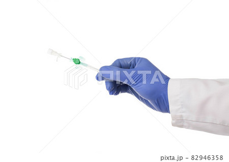 Doctor plastic surgeon holds in his hand a medical cannula for plastic surgery. White background, isolate, treatment 82946358
