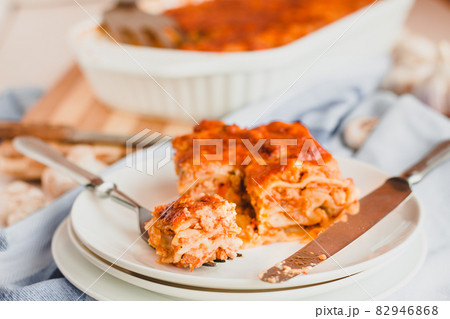 Piece of tasty hot lasagna served with on a white plate. Italian cuisine, menu, recipe. Homemade meat lasagna 82946868