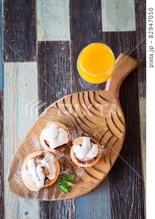 Homemade buns with cinnamon and a glass of juice. High quality photo. 82947050