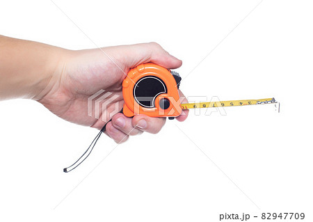 Man engineer holding a measuring tape in his hand on a white background, isolate. Close-up, centimeter 82947709