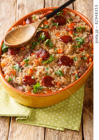 Arroz de pato or duck rice is a traditional Portuguese food close up in the baking dish. Vertical 82948353