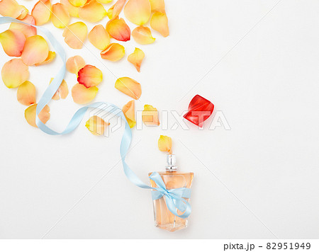 Delicate roses and perfume bottle on a white 82951949