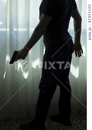 Pistol gun on table in room 82954320