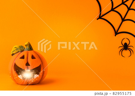 Happy halloween holiday concept. Jack o lantern, handmade paper decorations, spiders, web, ghosts on orange background. Halloween festival party, greeting card mockup with copy space 82955175
