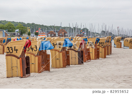 Roofed wicker beach chairs at beach of German village Laboe in summer Roofed wicker beach chairs at beach of German village Laboe in summer 82955652