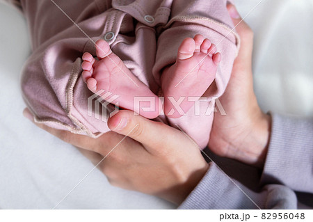 Newborn feets of caucasian newborn girl. Close-up. 82956048