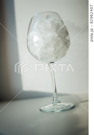 A glass with ice and a bottle of water A glass with ice and a bottle of water 82962407