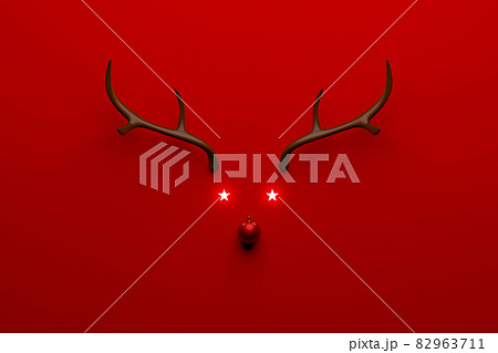 Christmas reindeer concept made of wooden and red bauble decoration and antlers on red background Christmas reindeer concept made of wooden and red bauble decoration and antlers on red background 82963711