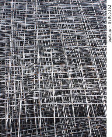Stack of steel construction mesh with rust. Steel mesh texture. Vertical photo 82965362
