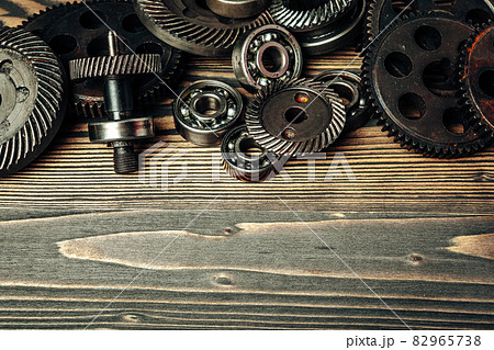 Car parts gears and bearings on wooden background 82965738