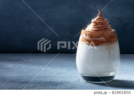 Dalgona cold coffee on a dark blue background with a place for text 82965850
