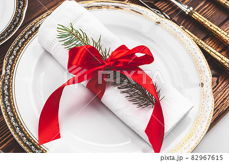 Brown wooden table with beautiful Christmas table setting Brown wooden table with beautiful Christmas table setting 82967615
