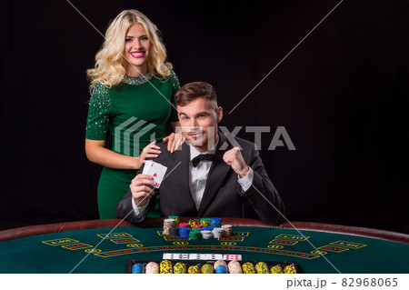 couple playing poker at the table. 82968065