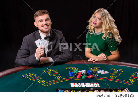 couple playing poker at the table. 82968135