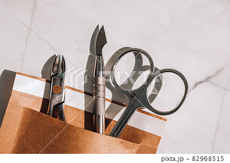 Clean manicure instruments. Manicure set in paper heat dry bag for sterilization. Sterilization of instruments healthcare concept Clean manicure instruments. Manicure set in paper heat dry bag for sterilization. Sterilization of instruments healthcare concept 82968515