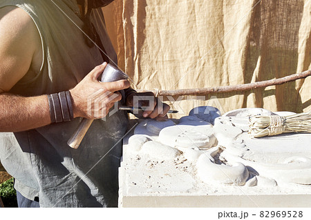 Craftsman carving stone in a traditional way. Concept of traditional Craftsman carving stone in a traditional way. Concept of traditional 82969528