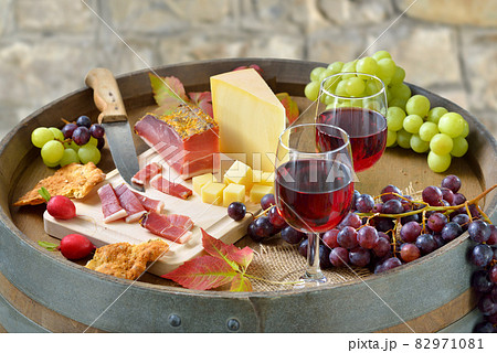 Hearty South Tyrolean snack with smoked bacon, tasty cheese, crunchy rye bread and red wine Hearty South Tyrolean snack with smoked bacon, tasty cheese, crunchy rye bread and red wine 82971081