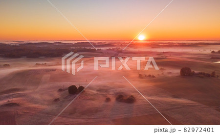 Amazing Sunrise Light Above Misty Landscape. Scenic View Of Foggy Morning In Misty Forest Park Woods. Summer Nature Of Eastern Europe. Sunset Dramatic Sunray Light Sunbeam. Amazing Sunrise Light Above Misty Landscape. Scenic View Of Foggy Morning In Misty Forest Park Woods. Summer Nature Of Eastern Europe. Sunset Dramatic Sunray Light Sunbeam. 82972401